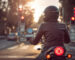 Motorcycle rider waiting at red light intersection