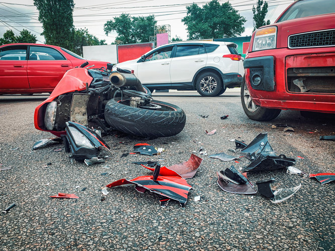 Motorcycle bike accident and car crash, broken and wrecked moto