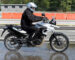 biker on road with helmet and wet asphalt