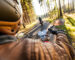 Man seat on the motorcycle on the forest road during sunrise.