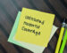 Concept of Uninsured Motorist Coverage write on sticky notes isolated on Wooden Table.