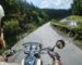 Biker in helmet driving his motorcycle on the open road by the river.
