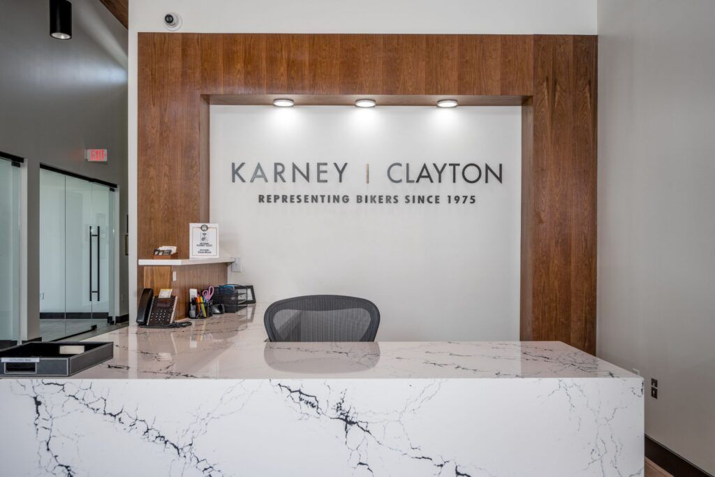 Karney Clayton reception desk with firm logo and tagline 'Representing Bikers Since 1975'
